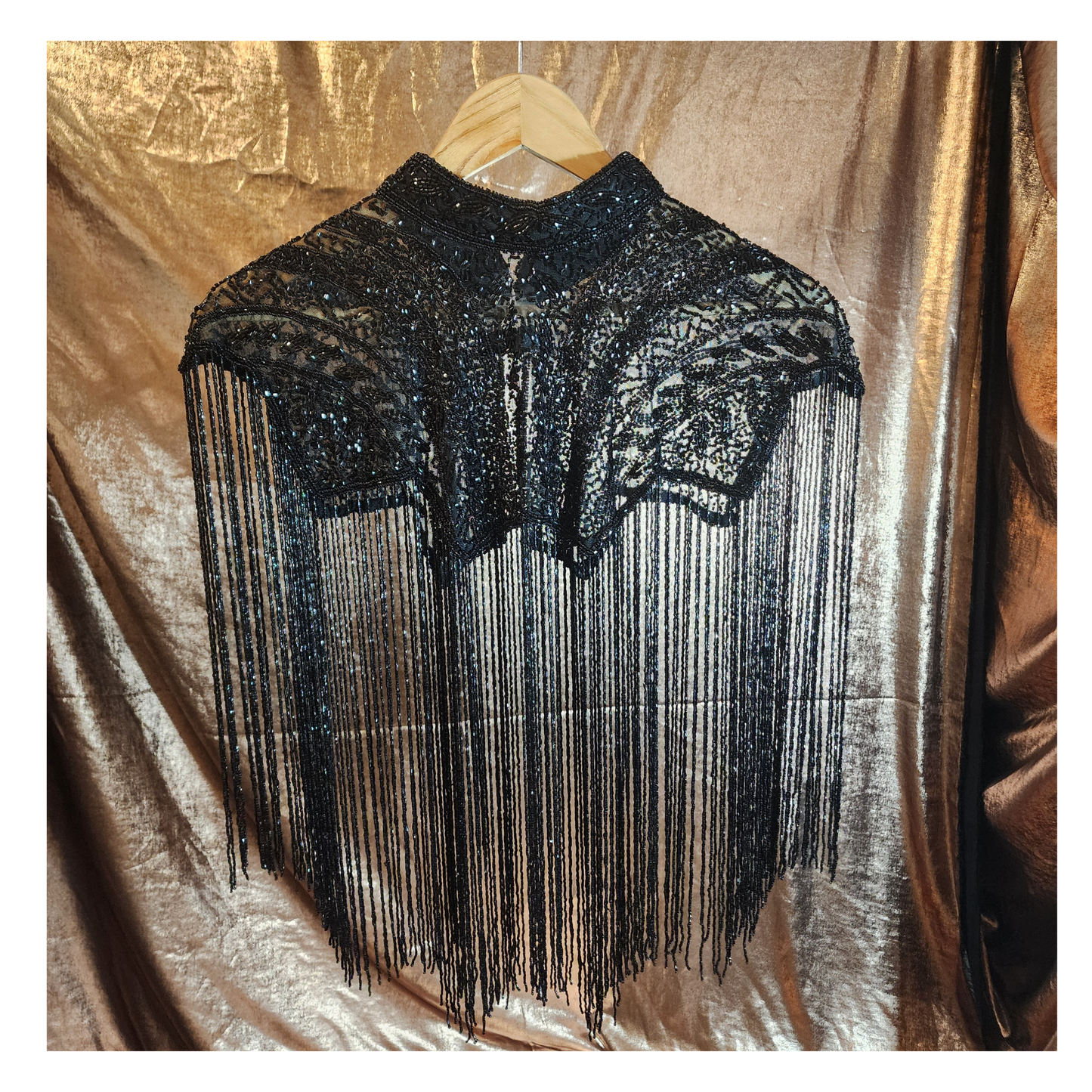 Hand-beaded cape on breathable mesh with soft tassels — designed to elevate any outfit.