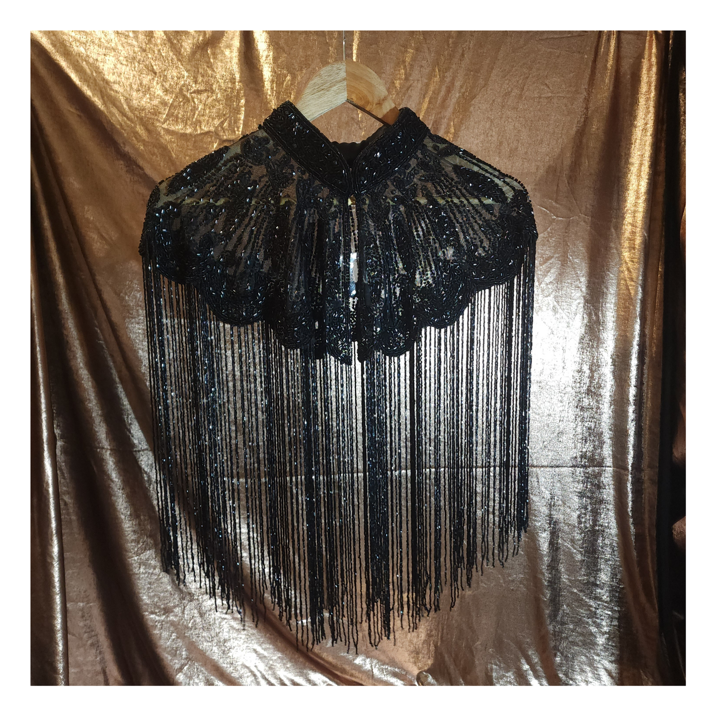 Hand-beaded cape on breathable mesh with soft tassels — designed to elevate any outfit.