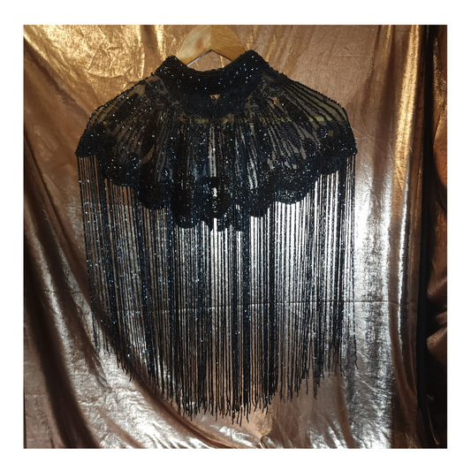 Hand-beaded cape on breathable mesh with soft tassels — designed to elevate any outfit.